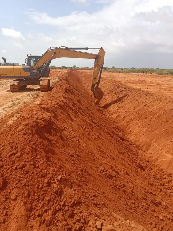Excavator digging out ditch